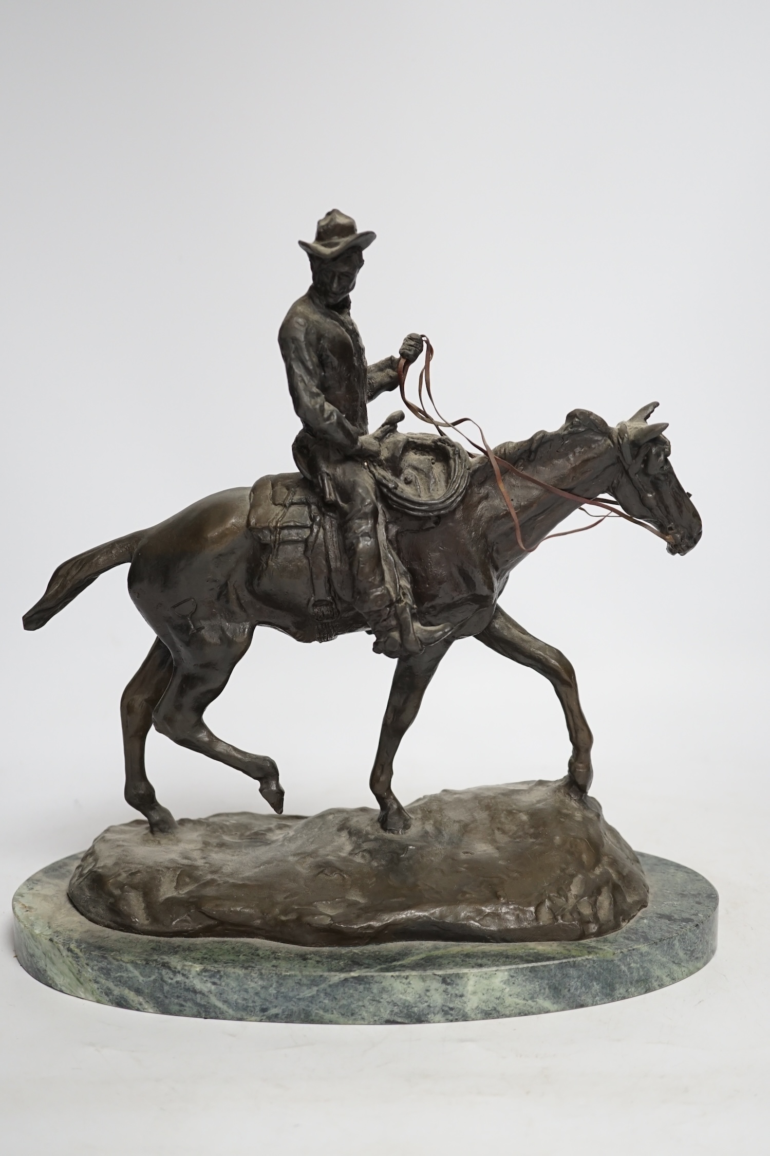 After Charles Marian Russell, a bronze group of Will Rogers, 29cm high